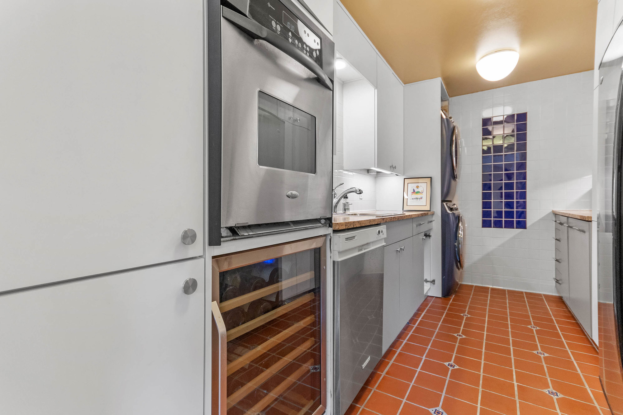 prep kitchen hallway with extra oven and wine fridge